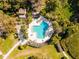 Aerial view of a community pool with unique design nestled in lush landscaping at 1711 Pelican Cove Rd # 443, Sarasota, FL 34231