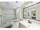 Bathroom featuring walk-in shower with an updated vanity at 1711 Pelican Cove Rd # 443, Sarasota, FL 34231