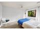 Bright bedroom with laminate flooring and a view of the lush, green outdoors at 1711 Pelican Cove Rd # 443, Sarasota, FL 34231