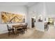 Bright dining room featuring an artistic accent wall and light wood-look flooring at 1711 Pelican Cove Rd # 443, Sarasota, FL 34231