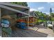 Kayak storage rack on a wooden dock filled with colorful kayaks and canoes near the waterfront community at 1711 Pelican Cove Rd # 443, Sarasota, FL 34231