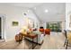 Bright and airy living room featuring vaulted ceiling, a desk, and sliding glass doors to a patio at 1711 Pelican Cove Rd # 443, Sarasota, FL 34231