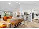 Bright, open living space with a view into the modern kitchen and dining area, all with sleek design at 1711 Pelican Cove Rd # 443, Sarasota, FL 34231
