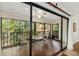 Enclosed patio features wood-look floors and views of the surrounding greenery at 1711 Pelican Cove Rd # 443, Sarasota, FL 34231