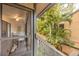 A peaceful porch view showcasing tropical greenery and glimpses of the home's dining area at 1711 Pelican Cove Rd # 443, Sarasota, FL 34231