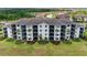 Aerial view of condo building with screened lanais and manicured landscaping at 17520 Gawthrop Dr # 103, Bradenton, FL 34211