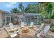 Outdoor backyard retreat featuring a firepit, adirondack chairs, and pool views at 1960 Lincoln Dr, Sarasota, FL 34236
