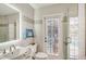 Modern bathroom features a glass-enclosed shower, a view to the pool, and a designer vanity at 1960 Lincoln Dr, Sarasota, FL 34236