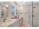 Bright bathroom featuring marble countertop, white cabinets, modern fixtures, and glass-enclosed shower at 1960 Lincoln Dr, Sarasota, FL 34236