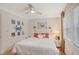 Comfortable bedroom with white walls, a crab art, a ceiling fan, and hardwood floors at 1960 Lincoln Dr, Sarasota, FL 34236