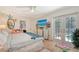 Bright bedroom featuring hardwood floors, pool access, and decoratively painted furnishings at 1960 Lincoln Dr, Sarasota, FL 34236