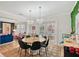 Elegant dining room with views of the pool outside and adorned with lovely chandeliers at 1960 Lincoln Dr, Sarasota, FL 34236