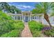 Inviting home with a brick pathway leading to a covered front porch and blue door at 1960 Lincoln Dr, Sarasota, FL 34236