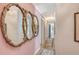 Hallway with pink walls and ornate mirrors adding elegance and visual interest at 1960 Lincoln Dr, Sarasota, FL 34236