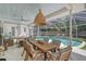 Outdoor living space features covered dining area, poolside lounge area, and ceiling fan for relaxation at 1960 Lincoln Dr, Sarasota, FL 34236