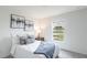 Serene bedroom with a plush bed, neutral tones, ample natural light, and modern décor at 21061 Delake Ave, Port Charlotte, FL 33954