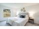 Cozy bedroom with natural light, a neutral color palette, plush carpeting, and stylish décor at 21061 Delake Ave, Port Charlotte, FL 33954
