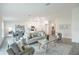 Open-concept living room with neutral decor, a tiled floor, and a view of the adjacent dining area and kitchen at 21061 Delake Ave, Port Charlotte, FL 33954