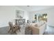 Bright living room with sliding glass doors to the yard and modern, neutral décor at 21061 Delake Ave, Port Charlotte, FL 33954