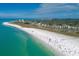 Stunning aerial view of a vibrant beach and coastline with turquoise waters and white sands near a bustling neighborhood at 2267 Pueblo Ln # V40, Sarasota, FL 34231
