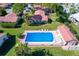 Aerial view of community pool with surrounding residences and vibrant landscaping at 2267 Pueblo Ln # V40, Sarasota, FL 34231