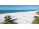 Sweeping aerial view of a beach with pristine white sand and the tranquil blue ocean on a clear day at 2267 Pueblo Ln # V40, Sarasota, FL 34231