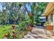 Beautiful backyard space featuring a garden, mature trees, and patio at 2267 Pueblo Ln # V40, Sarasota, FL 34231