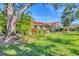 Beautiful backyard with vibrant greenery, mature trees, and vibrant landscaping at 2267 Pueblo Ln # V40, Sarasota, FL 34231