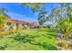Expansive backyard featuring a lush lawn and meticulous landscaping at 2267 Pueblo Ln # V40, Sarasota, FL 34231