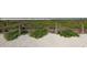 Picturesque beach access with native plants and a rustic rope fence, leading to the sandy shores at 2267 Pueblo Ln # V40, Sarasota, FL 34231