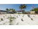 Beach entrance featuring an open-air pavilion, grassy dunes, and a clear blue sky on a sunny day at 2267 Pueblo Ln # V40, Sarasota, FL 34231