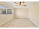 Neutral bedroom with a ceiling fan, carpet, and a window that provides natural light at 2267 Pueblo Ln # V40, Sarasota, FL 34231