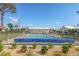 Community pool with crystal clear water and cozy lounge chairs around it at 2267 Pueblo Ln # V40, Sarasota, FL 34231