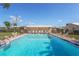 Sparkling community pool with ample seating and a pristine deck at 2267 Pueblo Ln # V40, Sarasota, FL 34231