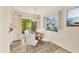 Dining area with wood-look tile floors, sliding glass doors to patio, and a round table at 2267 Pueblo Ln # V40, Sarasota, FL 34231