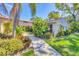 Beautiful front exterior of home with mature landscaping and red tile roof at 2267 Pueblo Ln # V40, Sarasota, FL 34231