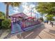 Quirky fudge shop with vibrant purple and blue exterior and outdoor patio seating at 2267 Pueblo Ln # V40, Sarasota, FL 34231