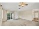 Spacious living room with natural light, carpeted floors and a ceiling fan at 2267 Pueblo Ln # V40, Sarasota, FL 34231