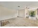 Open-concept living room with ample space, modern lighting, and a view to the lanai at 2267 Pueblo Ln # V40, Sarasota, FL 34231