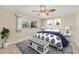 Bright bedroom with neutral colors, a window view, and a bed with a patterned comforter at 2267 Pueblo Ln # V40, Sarasota, FL 34231