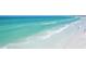 Clear turquoise ocean water meets a sandy beach on a sunny day at 2267 Pueblo Ln # V40, Sarasota, FL 34231