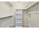 Walk-in closet with shelving, hanging rods, and carpeted flooring for optimal storage and organization at 2267 Pueblo Ln # V40, Sarasota, FL 34231