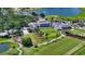 Expansive aerial view showcases the clubhouse, golf course, and waterfront of the community at 228 Saint James Park, Osprey, FL 34229