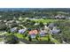 Beautiful aerial view of home, with enclosed pool, near the water and surrounded by golf course at 228 Saint James Park, Osprey, FL 34229