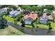 Aerial view of home with enclosed pool, surrounded by lush landscaping, near water and golf course at 228 Saint James Park, Osprey, FL 34229