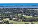 Aerial view of home on the golf course near the water, with serene landscaping at 228 Saint James Park, Osprey, FL 34229