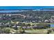 Aerial view of community and golf course featuring the water and nearby ocean at 228 Saint James Park, Osprey, FL 34229