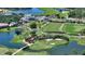 Aerial view of the golf course and community with waterways and sand traps at 228 Saint James Park, Osprey, FL 34229