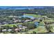 Beautiful aerial view of home on golf course, surrounded by lush landscaping and water views at 228 Saint James Park, Osprey, FL 34229