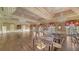 Spacious ballroom featuring hardwood floors, elegant lighting, and ample seating arrangements for special occasions at 228 Saint James Park, Osprey, FL 34229